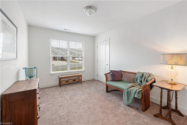 living area with carpet flooring, visible vents, and baseboards