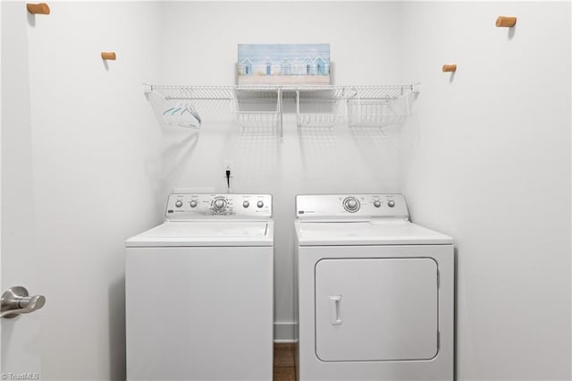 clothes washing area featuring laundry area and separate washer and dryer