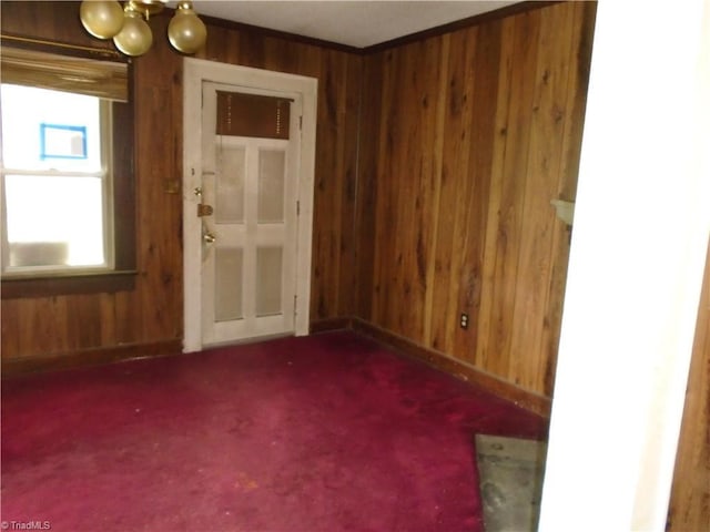 815 Camel Ave, Winston-Salem, NC 27101 - spare room featuring wooden walls, carpet, a chandelier, and baseboards