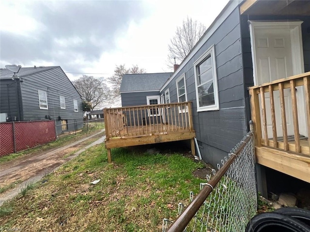 view of yard featuring a wooden deck and fence
