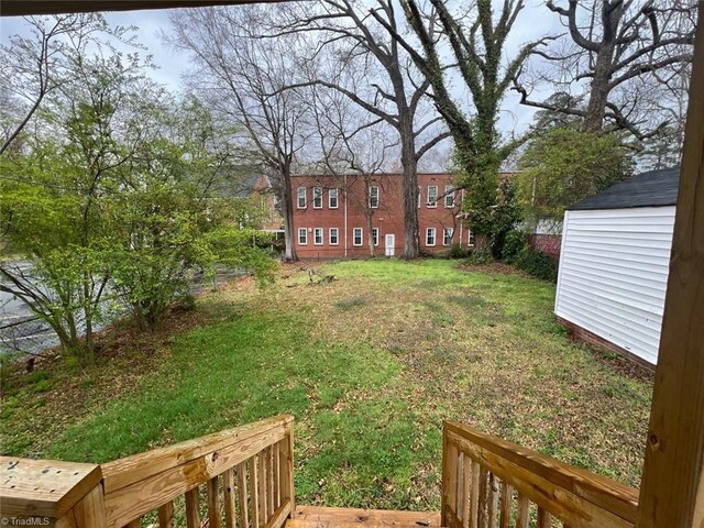 view of yard featuring a storage unit and an outbuilding