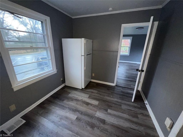 interior space featuring visible vents, crown molding, baseboards, and dark wood-style flooring