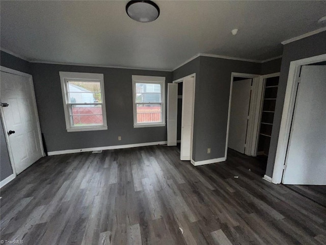 unfurnished bedroom with baseboards, dark wood-type flooring, and ornamental molding