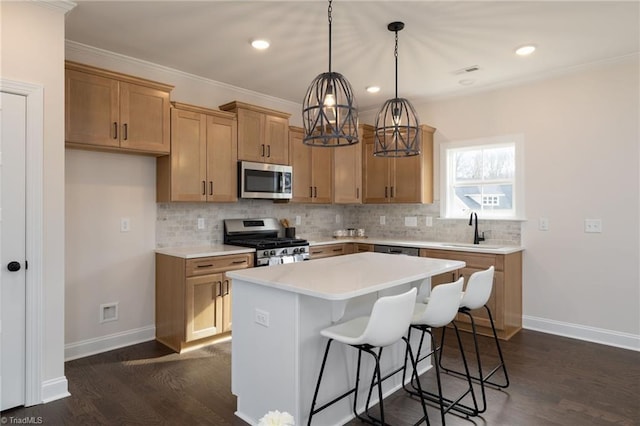 kitchen featuring a center island, backsplash, appliances with stainless steel finishes, dark wood-type flooring, and baseboards