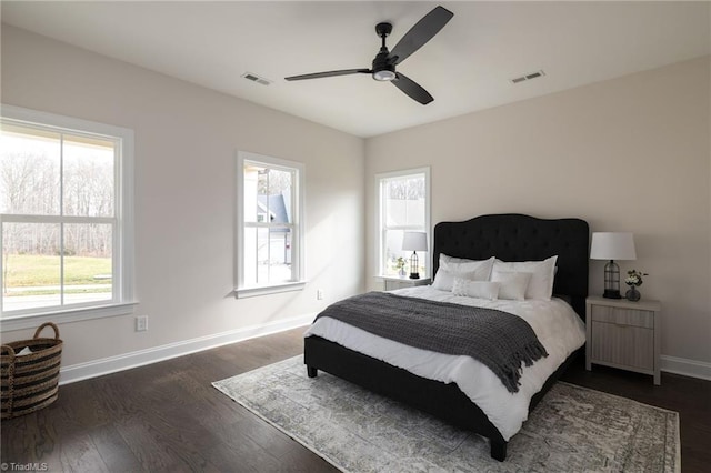 bedroom with a ceiling fan, baseboards, visible vents, and dark wood-type flooring