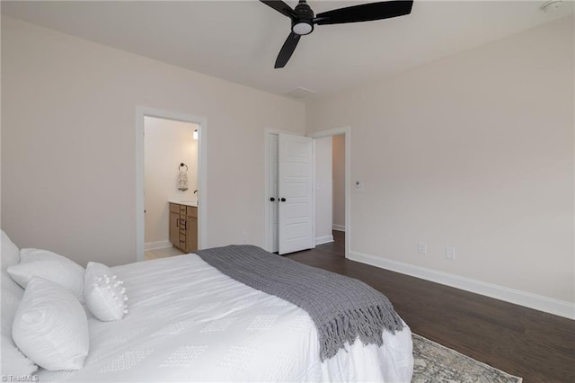 bedroom featuring a ceiling fan, connected bathroom, baseboards, and wood finished floors