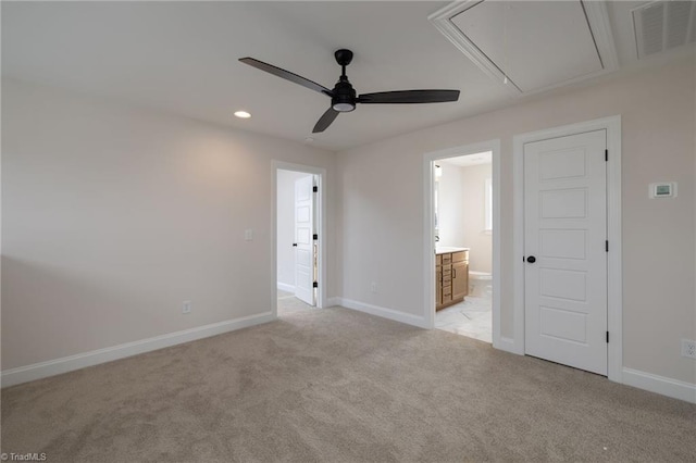 unfurnished bedroom with attic access, visible vents, baseboards, and light colored carpet