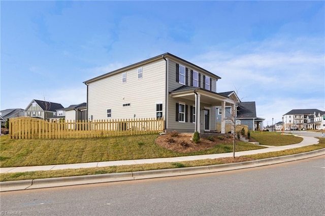 view of side of property with a residential view and fence