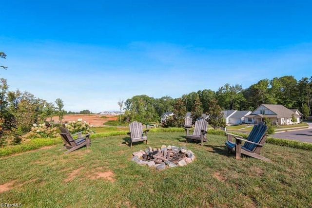 view of yard featuring an outdoor fire pit