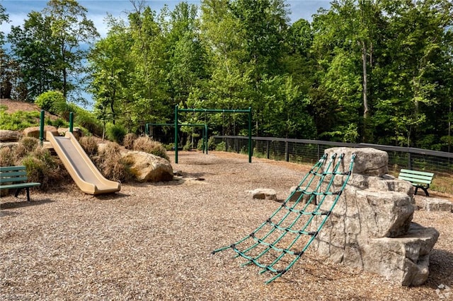 community jungle gym featuring fence