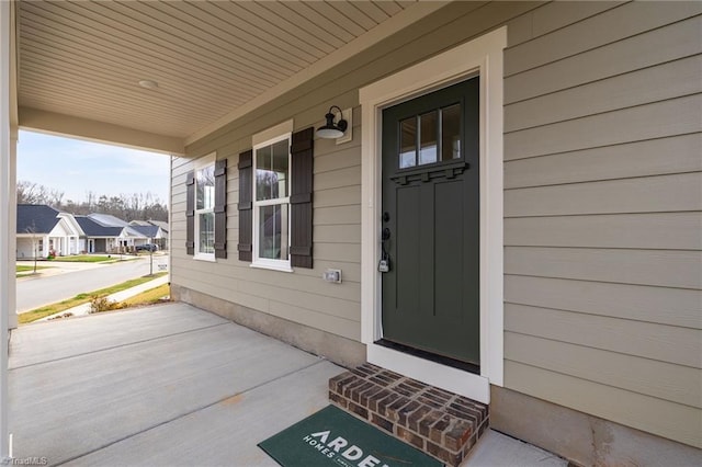 doorway to property with a residential view and a porch