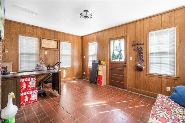 entryway with wood walls and baseboards