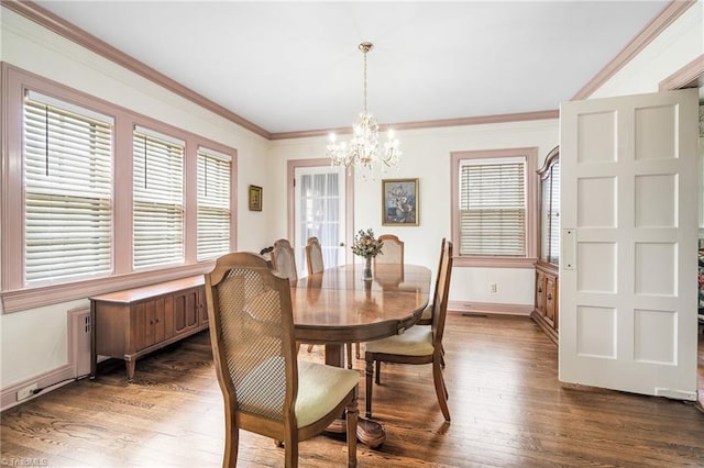 dining space featuring ornamental molding, dark wood-type flooring, and a healthy amount of sunlight