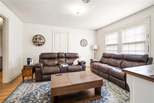 living room featuring baseboards and light wood finished floors