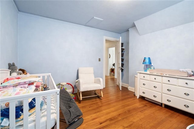 bedroom featuring light wood-type flooring and baseboards