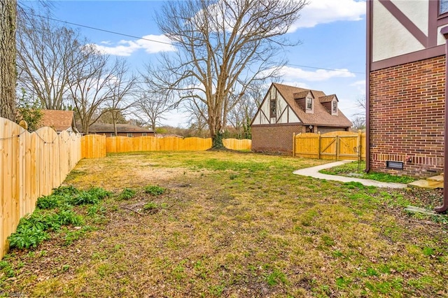 view of yard featuring a gate and a fenced backyard