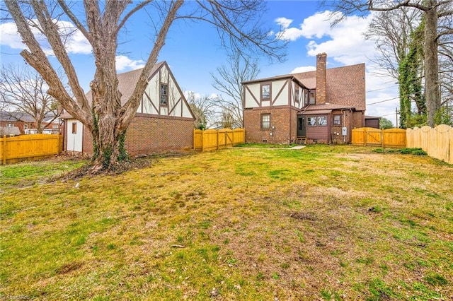 view of yard featuring a fenced backyard and a gate