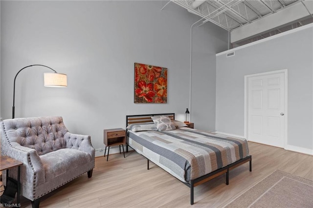 215 S Jefferson Ave Unit 102, West Jefferson, NC 28694 - bedroom with a high ceiling and light wood-style floors