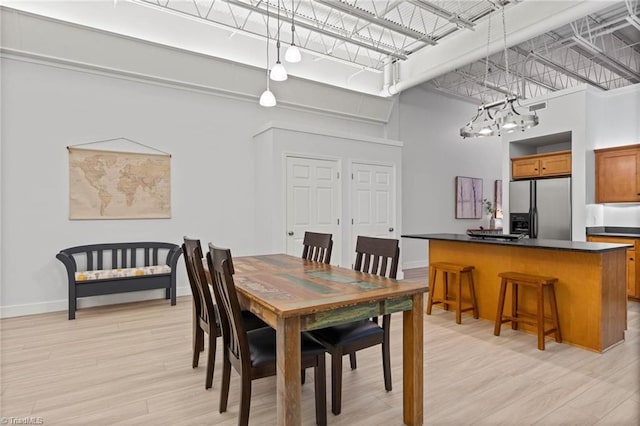 215 S Jefferson Ave Unit 102, West Jefferson, NC 28694 - dining space featuring a high ceiling and light wood-type flooring