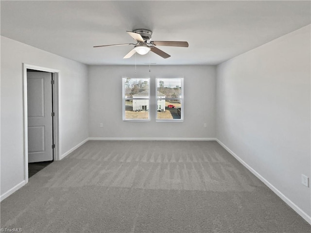 empty room featuring carpet, baseboards, and ceiling fan