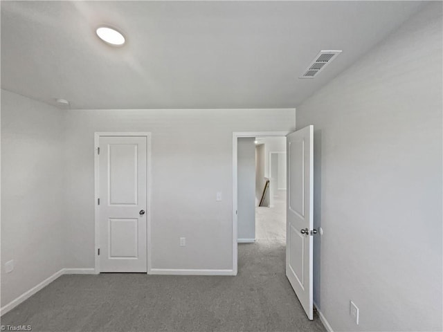 unfurnished bedroom featuring light carpet, baseboards, and visible vents