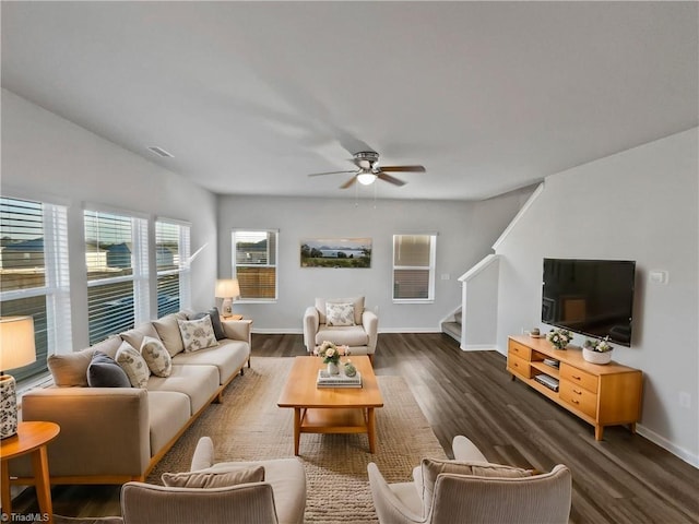 living room with ceiling fan, stairs, baseboards, and dark wood finished floors