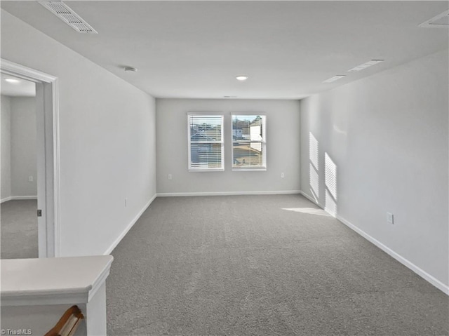 unfurnished living room featuring baseboards, visible vents, and carpet flooring