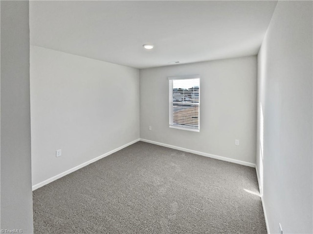 carpeted empty room with baseboards