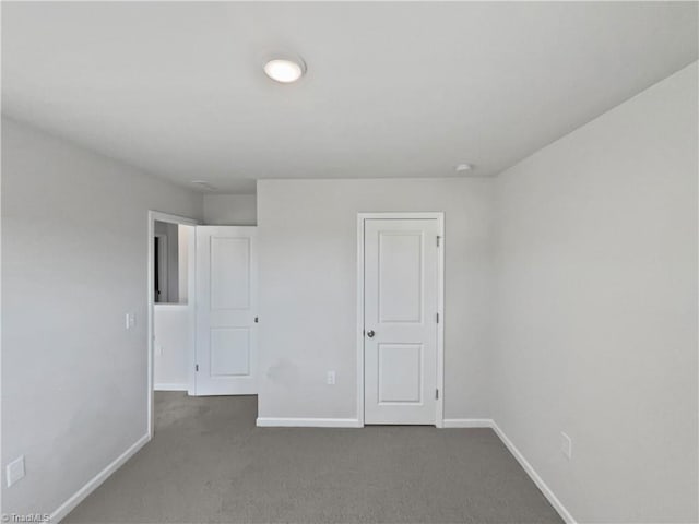 unfurnished bedroom featuring baseboards and carpet flooring