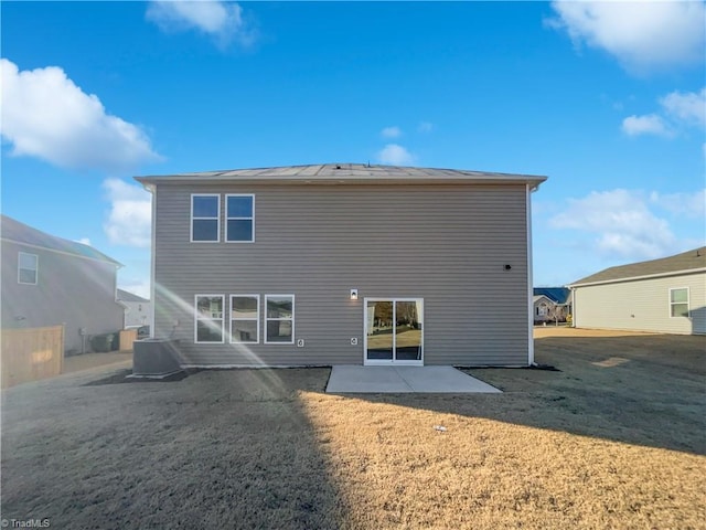 rear view of house featuring a yard, cooling unit, and a patio