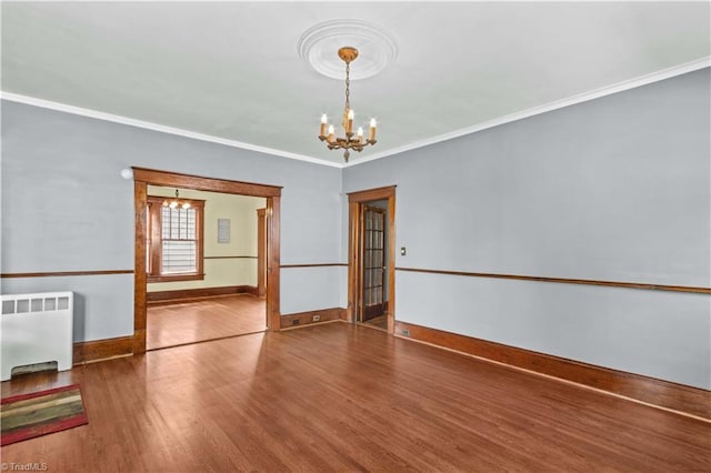 119 Wiley Ave, Salisbury, NC 28144 - unfurnished room featuring radiator heating unit, a chandelier, wood finished floors, baseboards, and ornamental molding