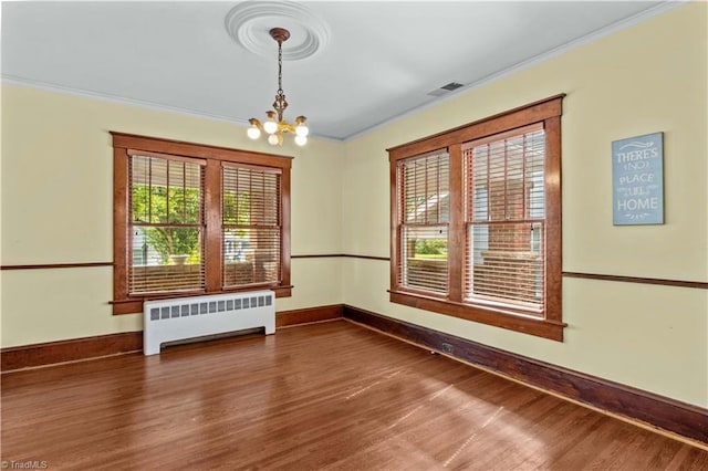 119 Wiley Ave, Salisbury, NC 28144 - empty room featuring radiator, wood finished floors, crown molding, a chandelier, and baseboards