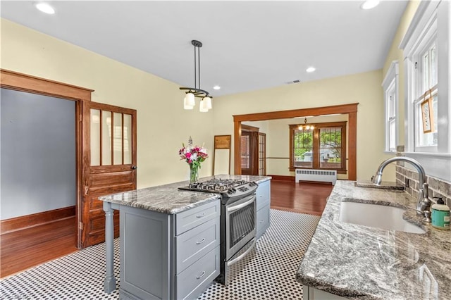 119 Wiley Ave, Salisbury, NC 28144 - kitchen featuring a sink, radiator, stainless steel gas range, gray cabinetry, and wood finished floors