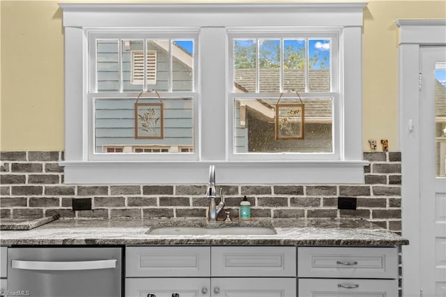 119 Wiley Ave, Salisbury, NC 28144 - kitchen featuring dishwasher, a sink, backsplash, and dark stone counters