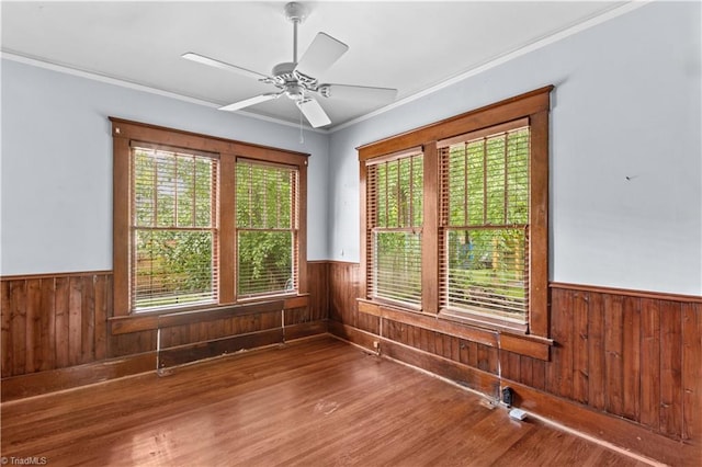 119 Wiley Ave, Salisbury, NC 28144 - unfurnished room featuring a wainscoted wall, plenty of natural light, wood walls, wood finished floors, and ornamental molding
