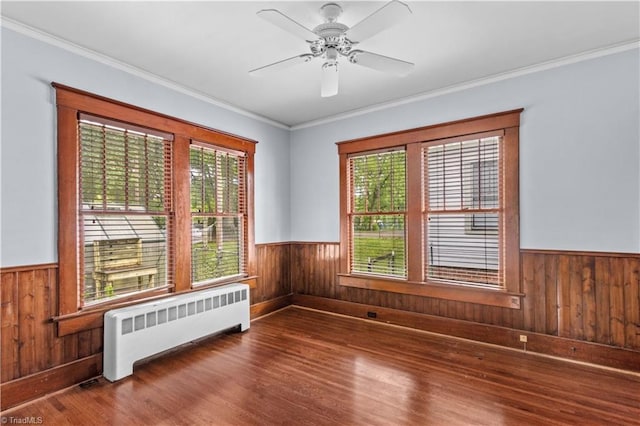 119 Wiley Ave, Salisbury, NC 28144 - spare room with radiator, wooden walls, wainscoting, wood finished floors, and ornamental molding