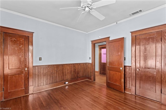 119 Wiley Ave, Salisbury, NC 28144 - empty room featuring crown molding, a wainscoted wall, wood finished floors, a ceiling fan, and wood walls