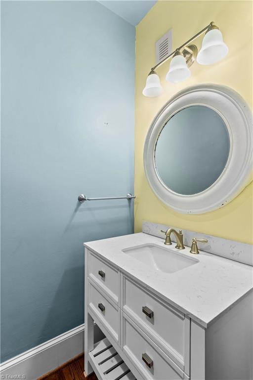 119 Wiley Ave, Salisbury, NC 28144 - bathroom featuring vanity, wood finished floors, and baseboards