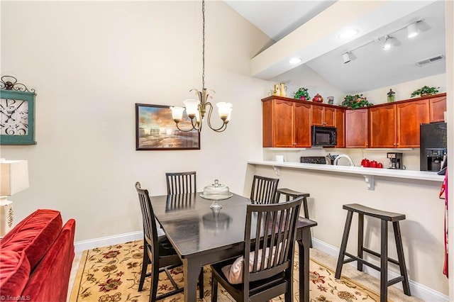 1627 Crestlawn Trl, Pfafftown, NC 27040 - dining room with vaulted ceiling, a chandelier, baseboards, and recessed lighting