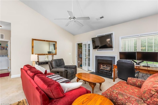 1627 Crestlawn Trl, Pfafftown, NC 27040 - carpeted living area with washer / clothes dryer, a ceiling fan, a fireplace with flush hearth, lofted ceiling, and baseboards