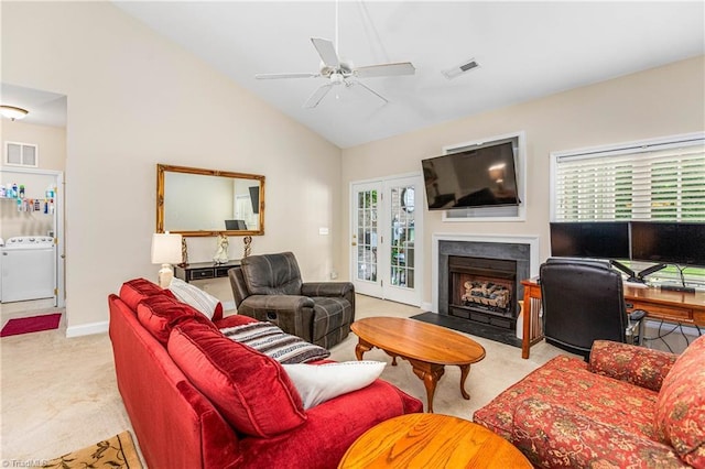 1627 Crestlawn Trl, Pfafftown, NC 27040 - living area featuring washer / dryer, carpet floors, ceiling fan, lofted ceiling, and a fireplace with flush hearth
