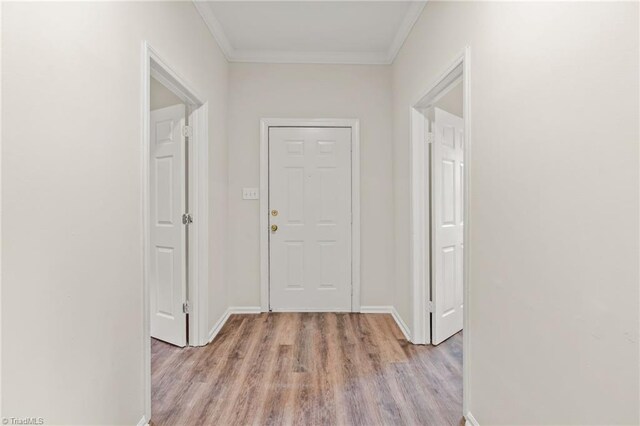 interior space with light wood-type flooring and crown molding