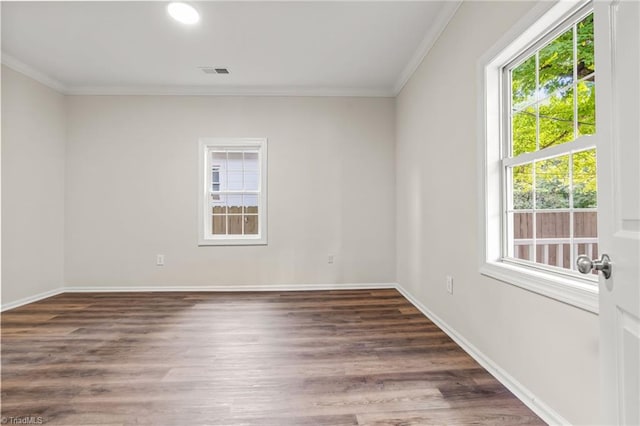 spare room featuring crown molding and dark hardwood / wood-style floors