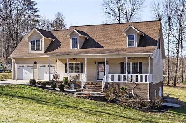 cape cod house with ceiling fan, covered porch, a garage, driveway, and a front lawn