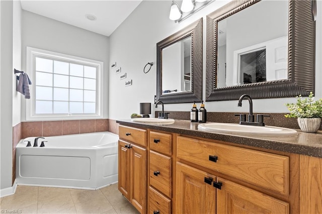 bathroom featuring a bath, double vanity, a sink, and tile patterned floors