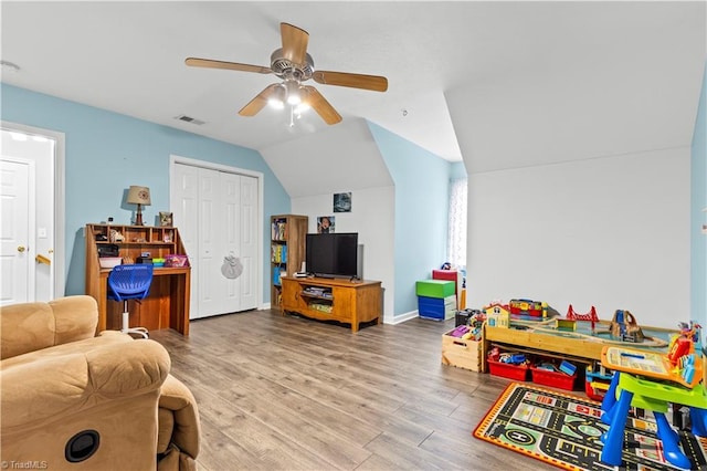 game room with visible vents, ceiling fan, vaulted ceiling, wood finished floors, and baseboards