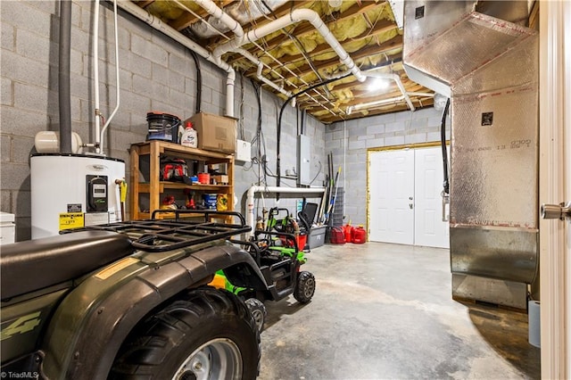 basement featuring water heater and concrete block wall