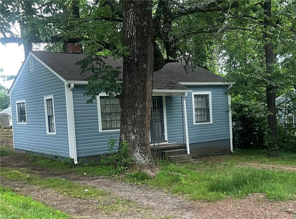 bungalow-style home featuring roof with shingles and crawl space