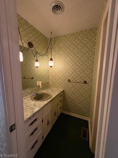 bathroom with vanity and a textured ceiling