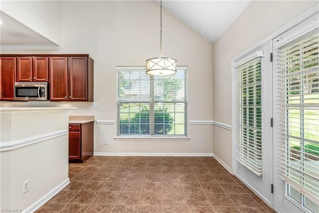 4012 Chianti Way, Greensboro, NC 27410 - kitchen featuring stainless steel microwave, healthy amount of natural light, lofted ceiling, hanging light fixtures, and baseboards